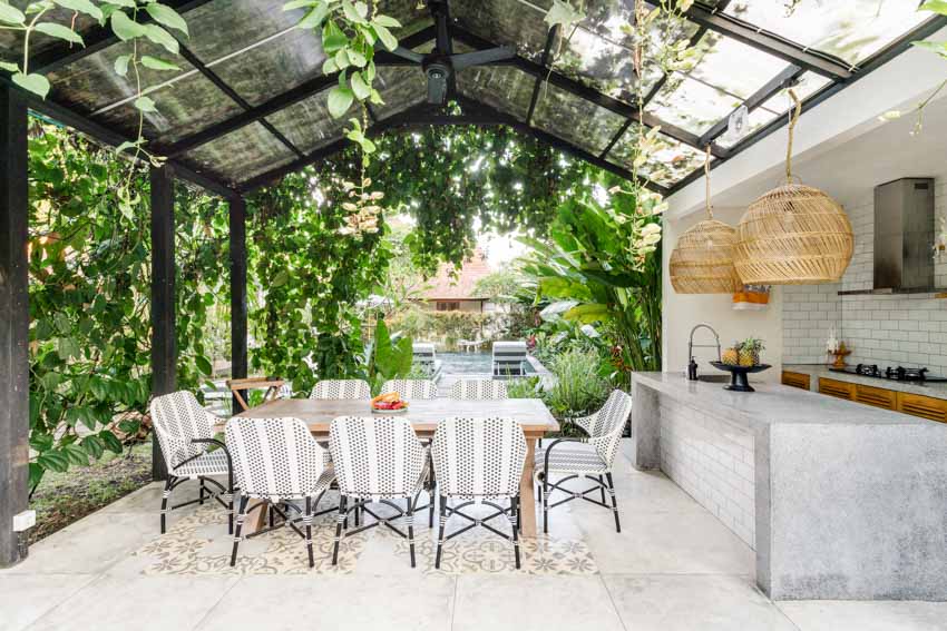 Outdoor area with kitchen, dining table, chairs, island, epoxy countertop, and pendant lighting