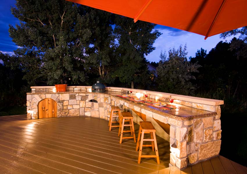 Outdoor kitchen with epoxy countertop, wood flooring, dining area, and stools