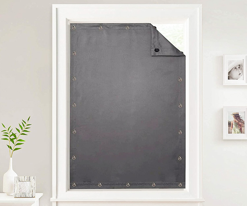 Portable blackout curtain attached to a window