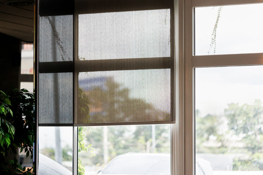 Portable blackout curtain attached to a window