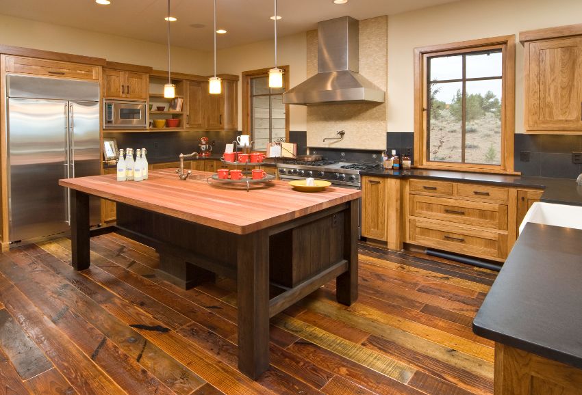 Rustic kitchen interior with RTA hickory cabinets, stainless steel appliances hardwood floors and island