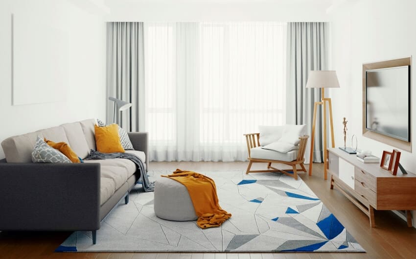 Scandinavian design living room with grey sofa and carpet, layered curtains and some wood accents