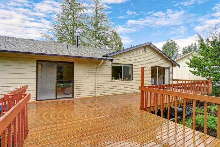 Backyard deck with wood railing and sliding door