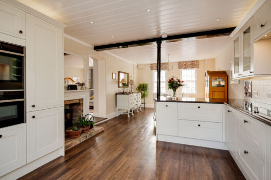 Spacious Kitchen With Mdf Cabinets Wood Floor Shiplap Ceiling And Countertops Is 531x354 
