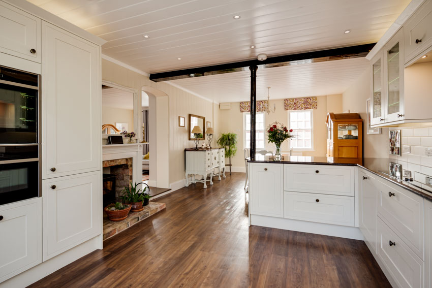 Spacious kitchen with cabinets, wood floor, shiplap ceiling, and countertops