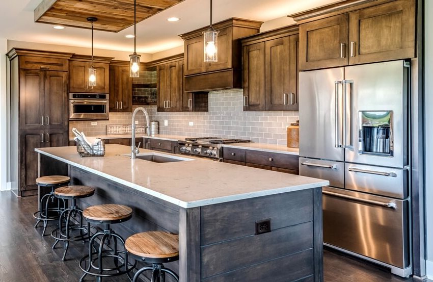 Farmhouse kitchen with solid wood cabinets, distressed wood island and pendant lights
