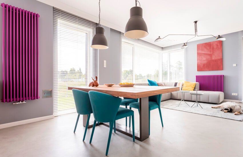 Trendy interior of dining area with turquoise chairs 