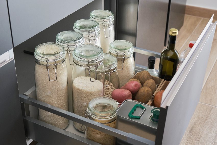 Variety of flours, rice, potatoes, onion, garlic, olive oil and vinegar in plug in drawer