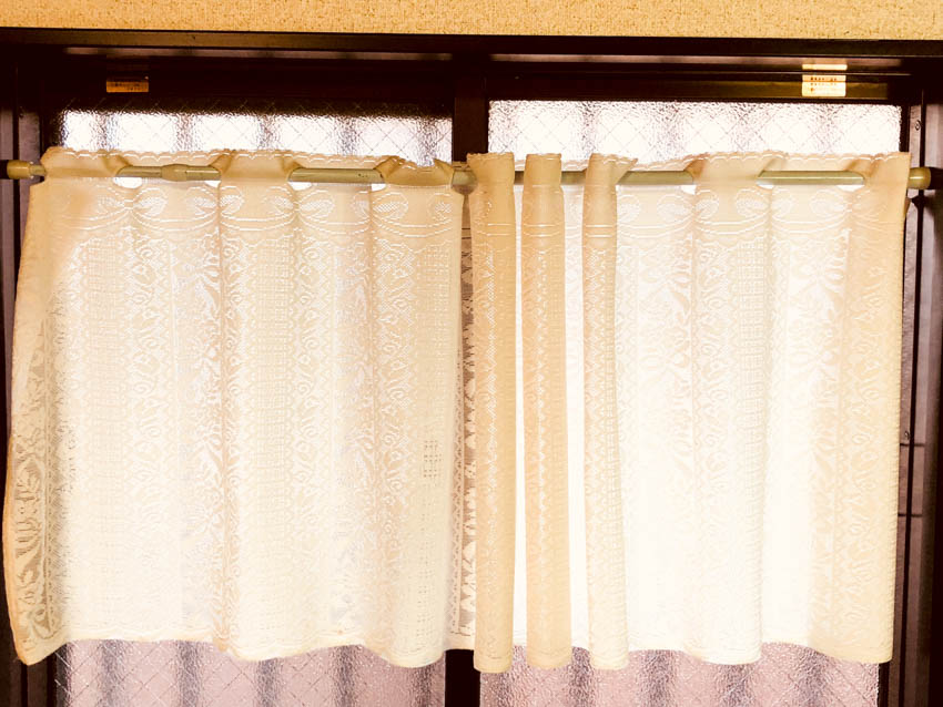 Window with a tier curtain attached to it