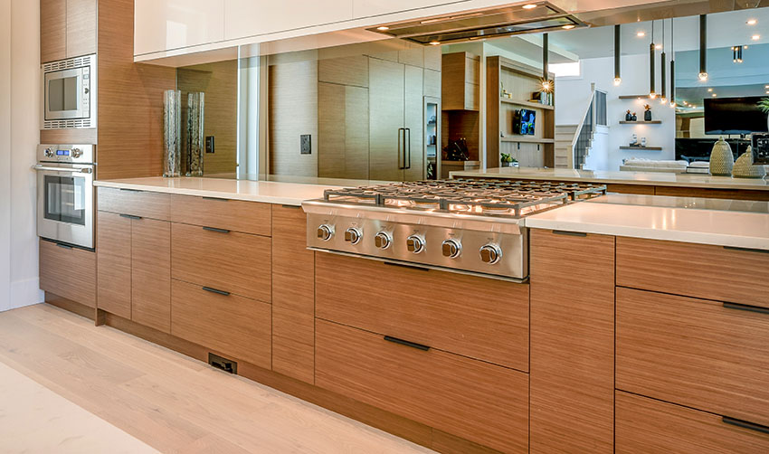 Modern kitchen with high end cabinets big stove mirror backsplash built-in oven