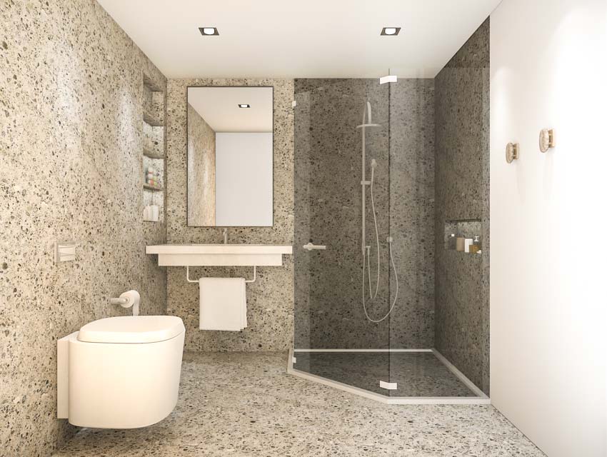 Bathroom with cultured granite shower wall, glass divider, floating countertop, mirror, and toilet