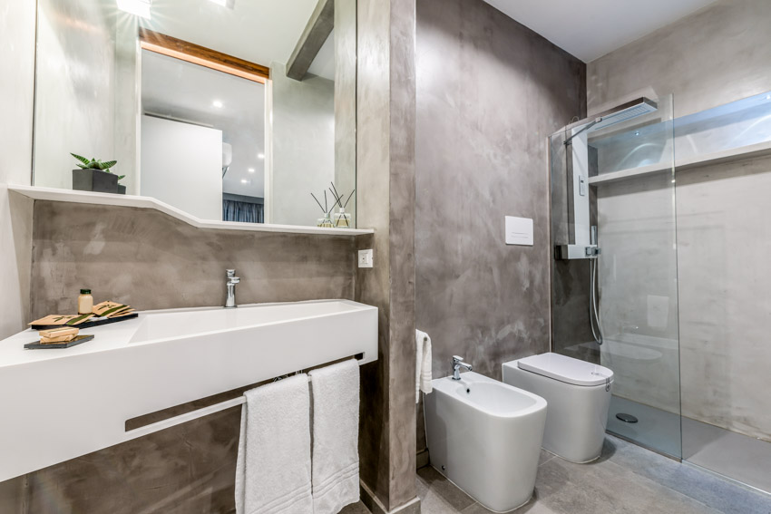Bathroom with epoxy shower toilet, bidet, floating vanity, and mirror