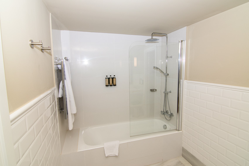 Bathroom with fiberglass shower, tub, and towel holder