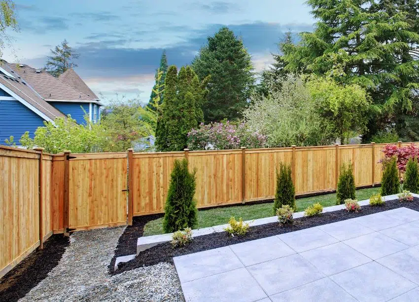 A beautiful backyard landscape, empty patio space with tile floor and Douglas fir fencing