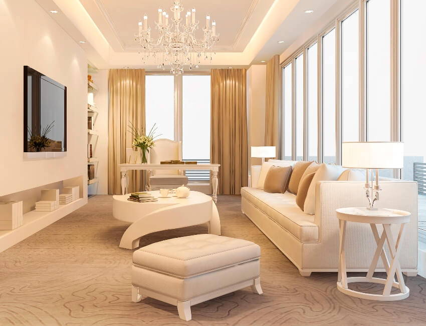 A beautiful beige luxury living room with carpet floors, white furniture, glass doors and windows with double sided curtain for doorway