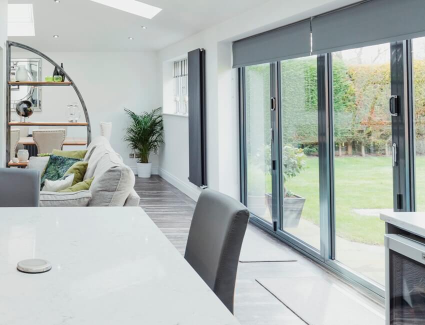 A beautiful contemporary kitchen and living room interior with glass sliding doors