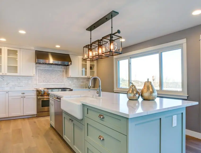 Kitchen with wooden floors, green island with farmhouse sink 