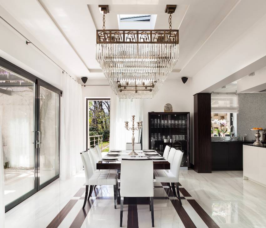 A large crystal chandelier in a Post Modern designed room