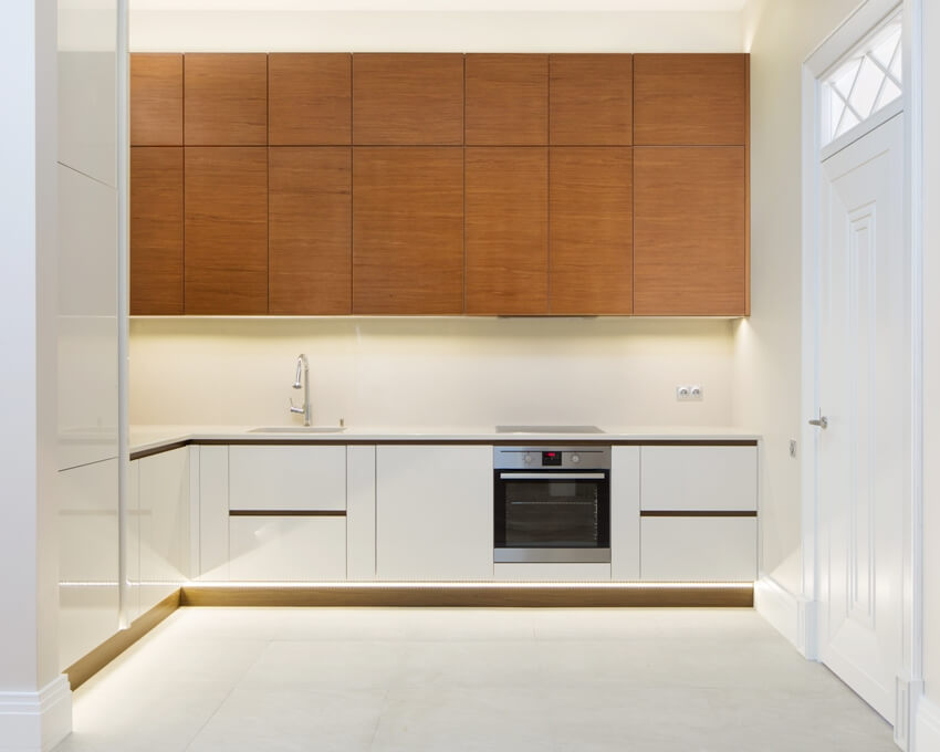 Kitchen with white counter, drawers and walls and overhead cabinets