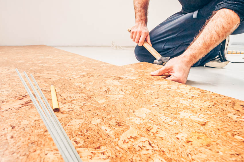 Contractor installing cork flooring for home interiors