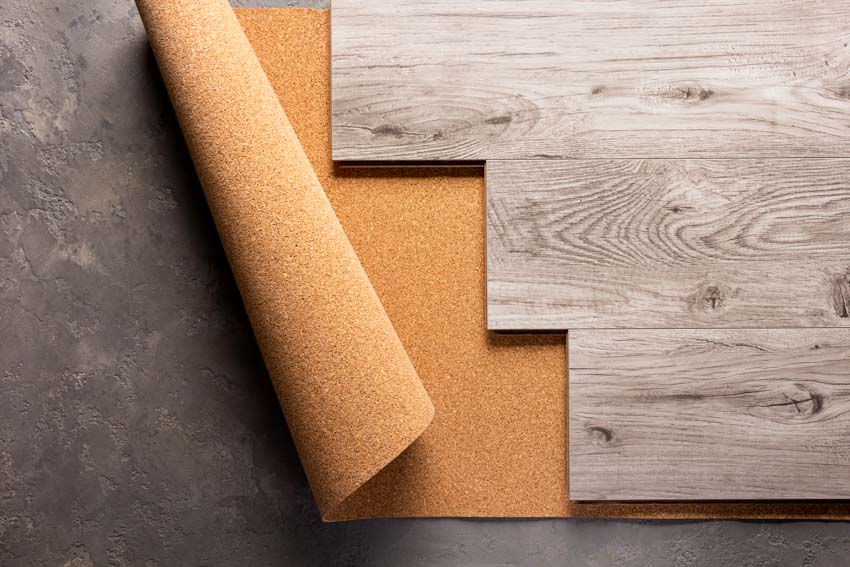 Cork sheet flooring under wood laminate planks for home interiors