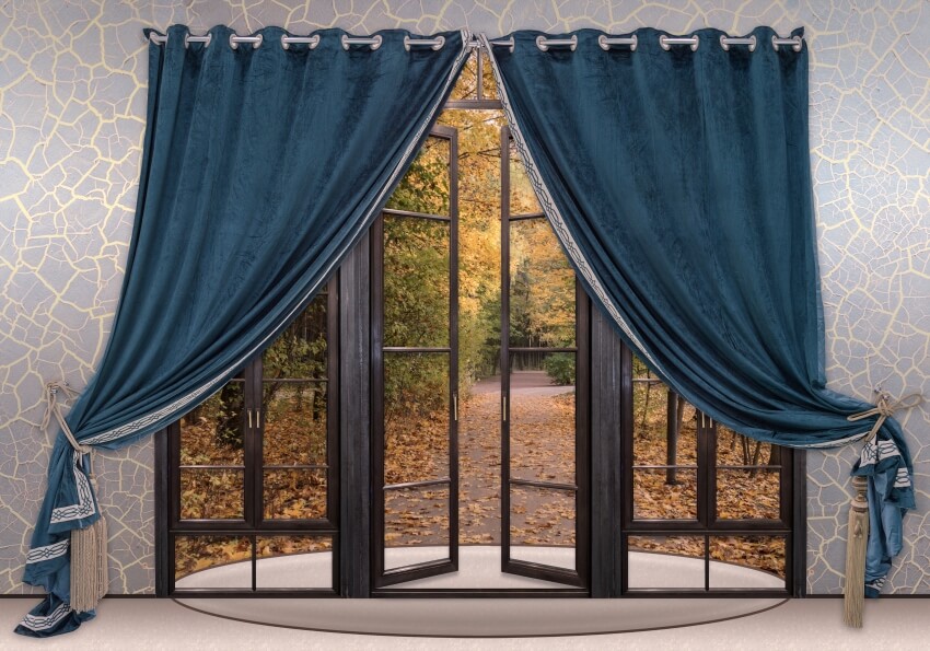 Dark blue velvet double sided curtains on doorway with view of the trees outside