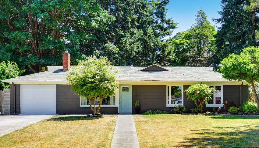 Dark gray exterior with garage and wide front yard