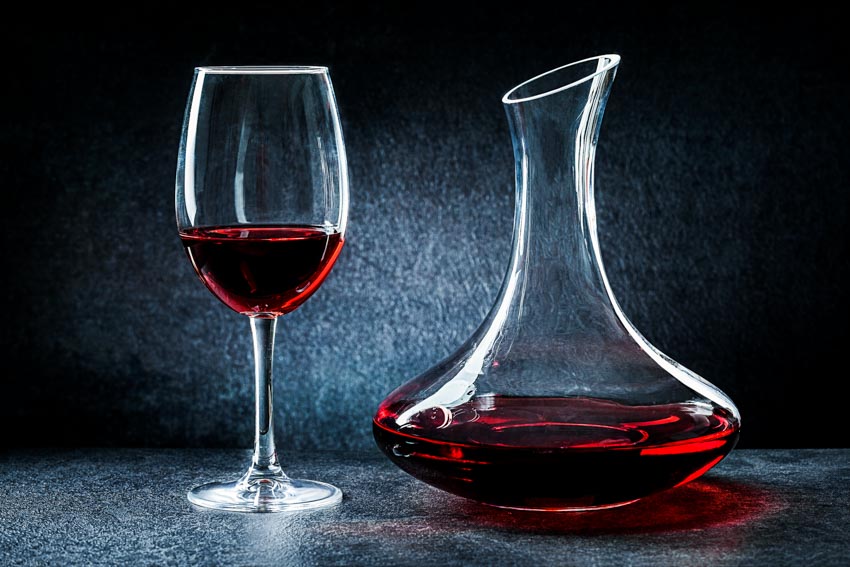Decanter with wine glass next to it