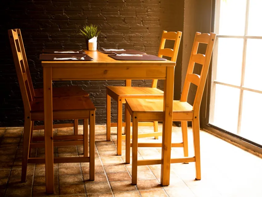Table, wood seats, brick wall, and window