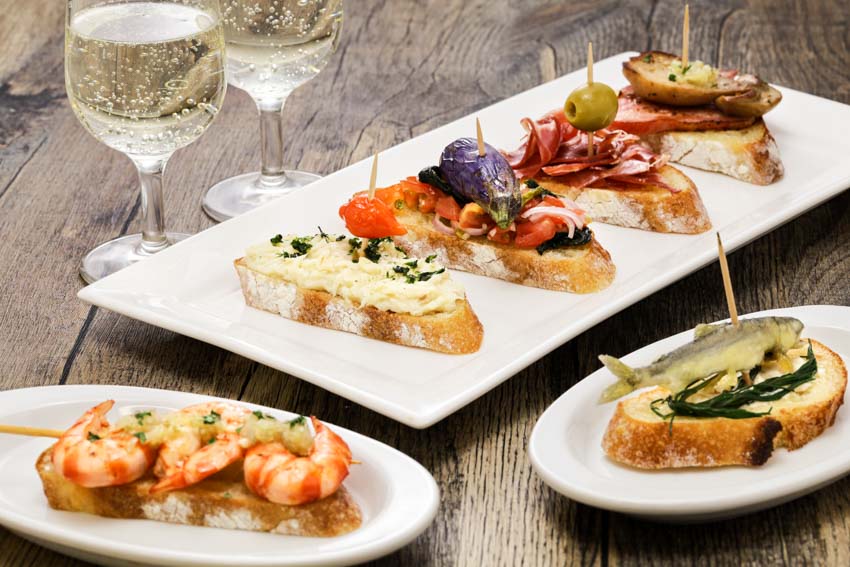 White appetizer plates and different hors d'oeuvres