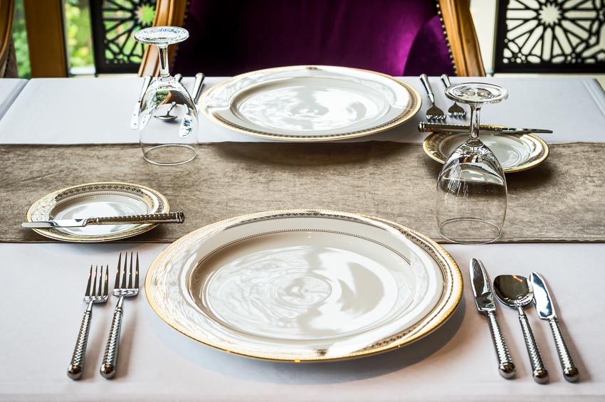 Dinner and salad plates, silver cutlery and table runner