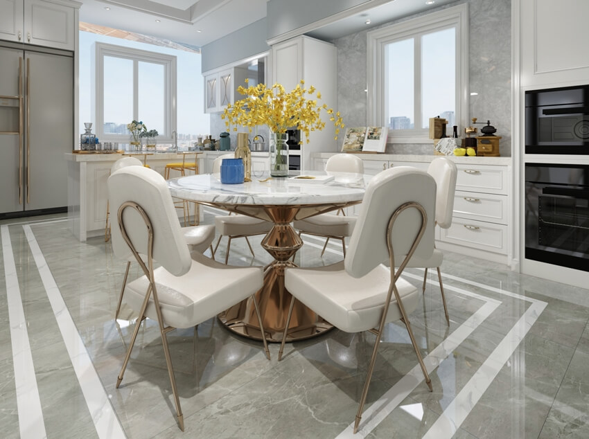 Elegant kitchen interior with beautiful dining set and lighting, built in ovens and large format porcelain tile flooring