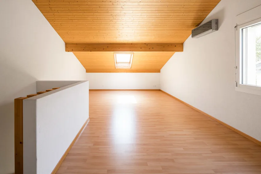 Empty attic with windows, wood floor, and beadboard ceiling