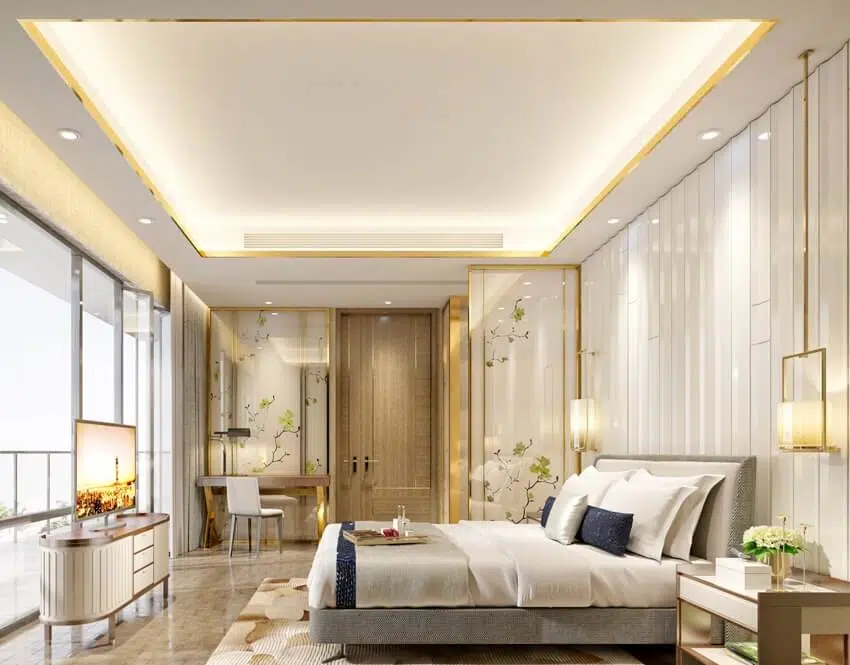 Bedroom with tray ceiling, recessed lighting and gold accents