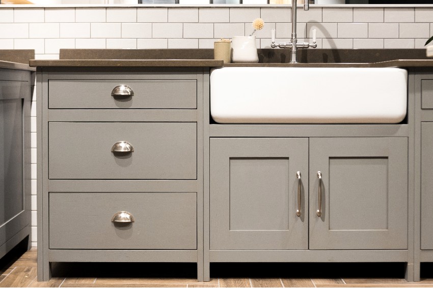 Gray kitchen counter with sink and inset cabinets