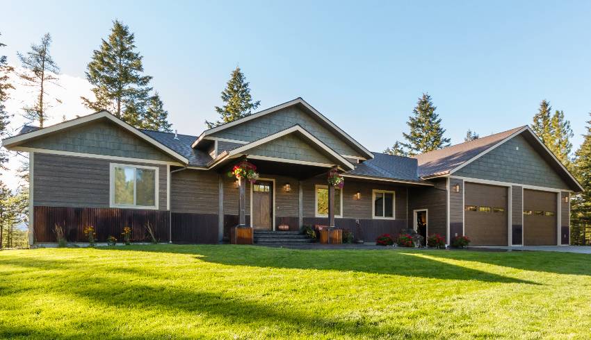 Green grass and lovely landscaping in front yard of new ranch design home