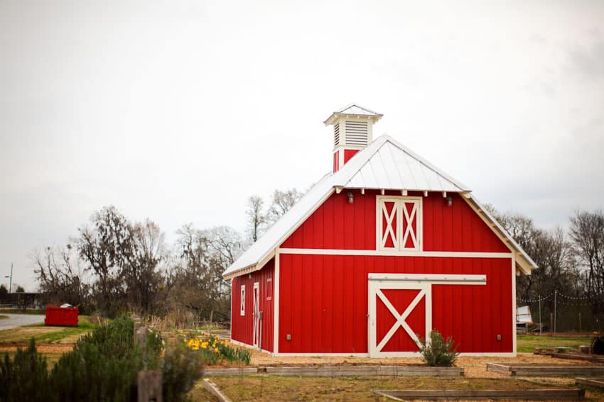 High country barn with red siding door, and angled roof