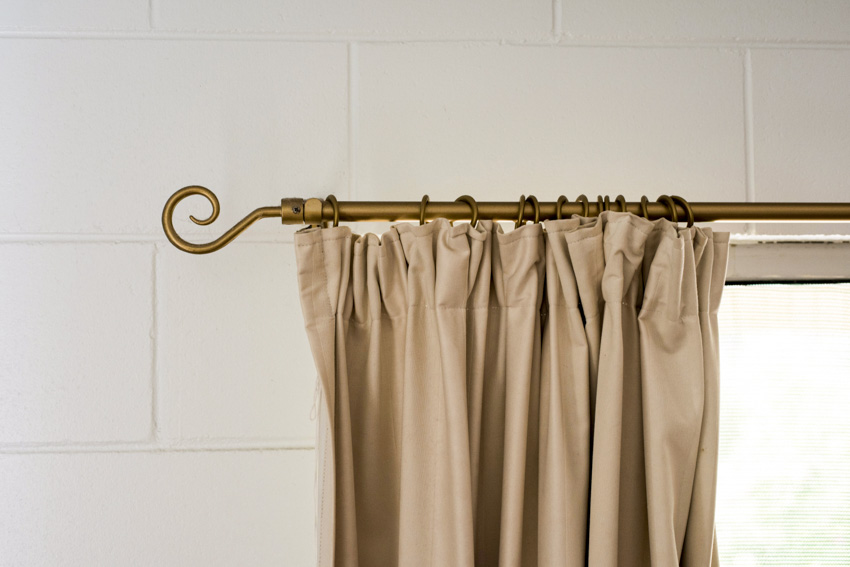 Gold curtain attached to a rod with hook end design