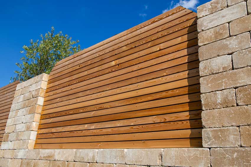 Horizontal wood slat fence with pillars at the side