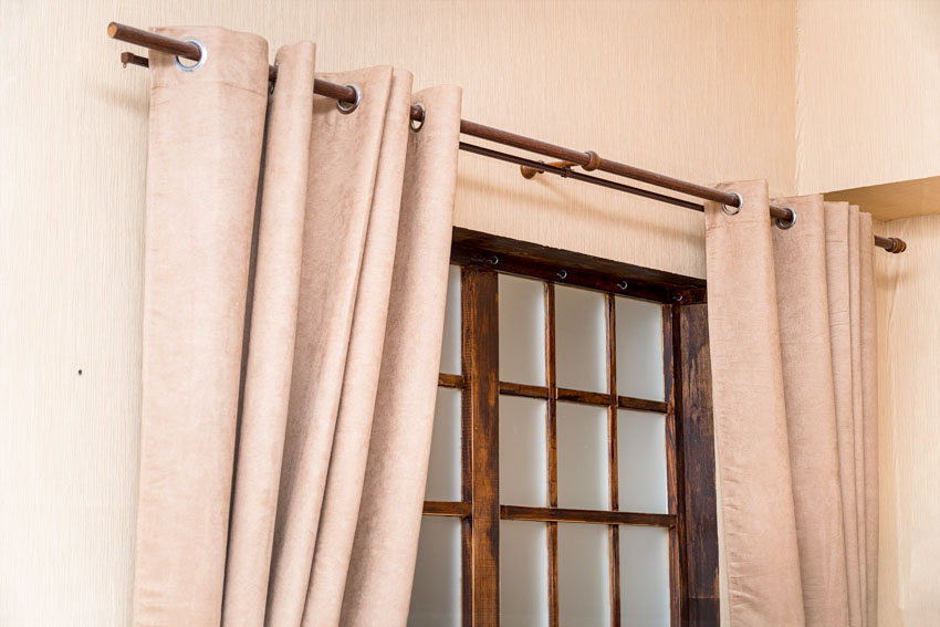 Wooden rod used for attaching curtains with grommets