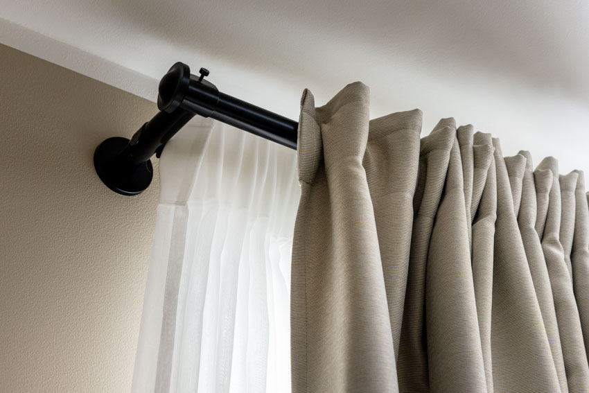 printed beige curtains set on heavy-duty rails 