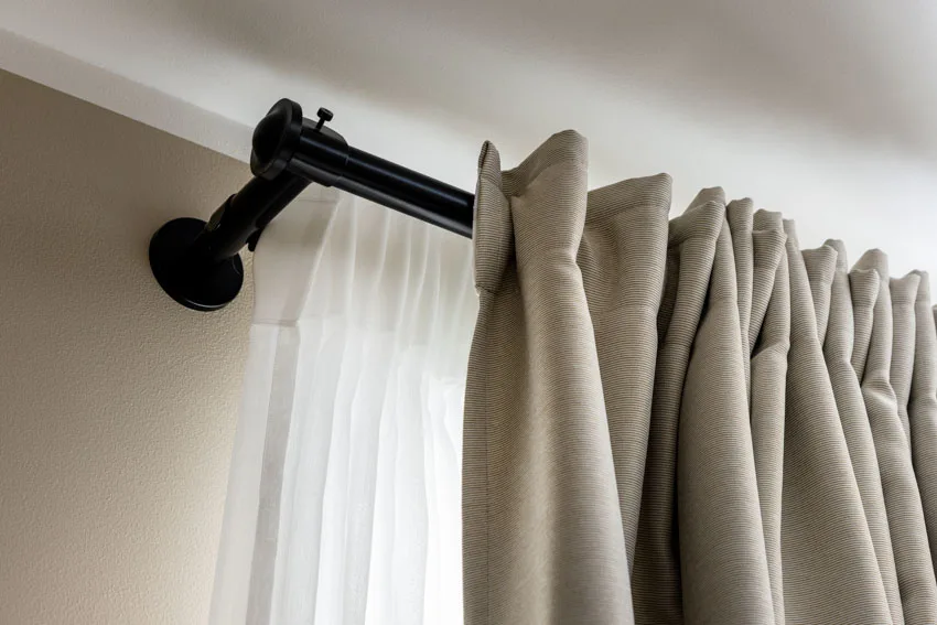 printed beige curtains set on heavy-duty rails 