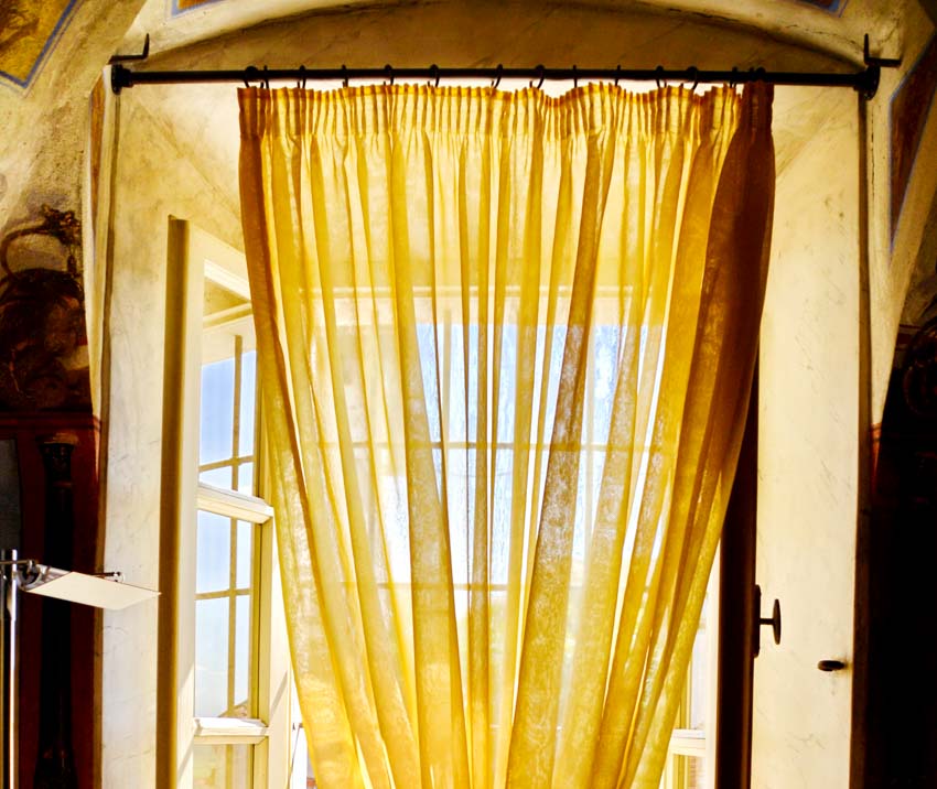 House interior with inside mount curtain rod, and yellow curtain