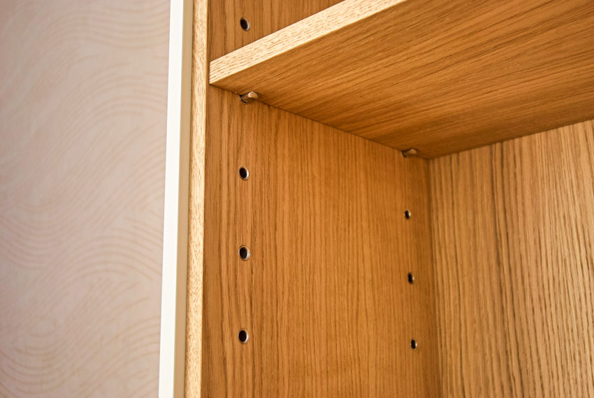 Interior of particle board cabinets with a shelf