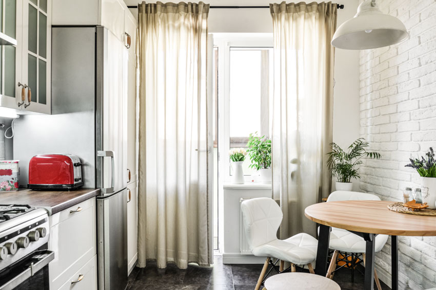 thin curtains in the kitchen attached to black rod 