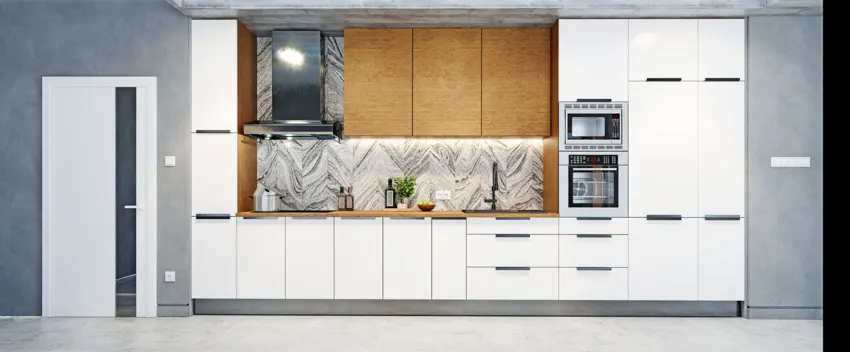 Kitchen with cabinets, oven, range hood, countertop, and onyx backsplash