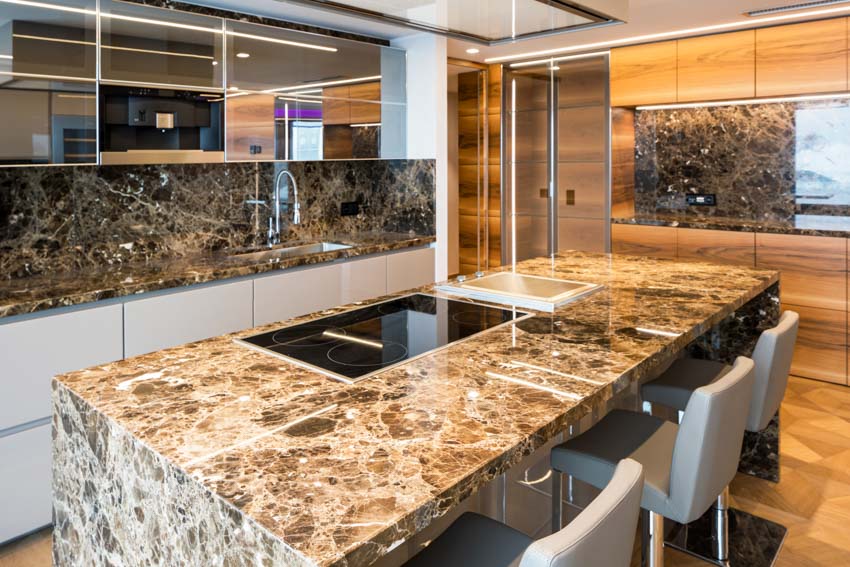 Kitchen with onyx countertops, island, backsplash, chairs, sink, and faucet