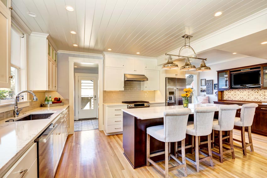 Kitchen with peninsula seating, white countertop and white painted ceiling