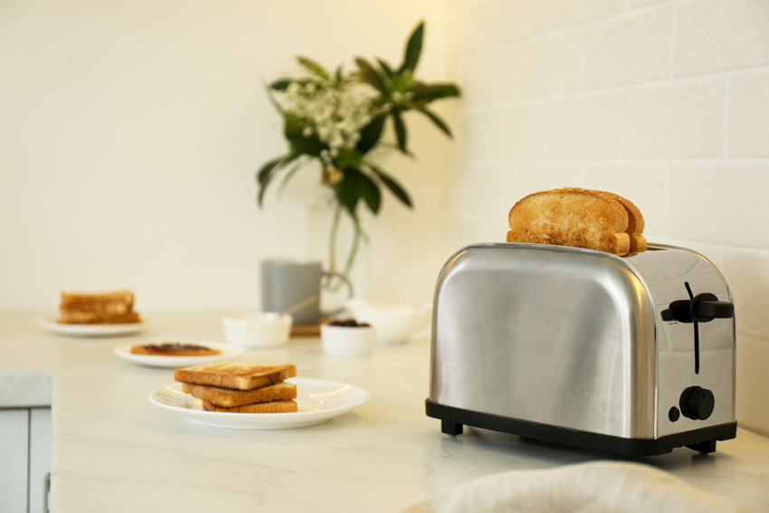 Kitchen with plates, bread, and toaster