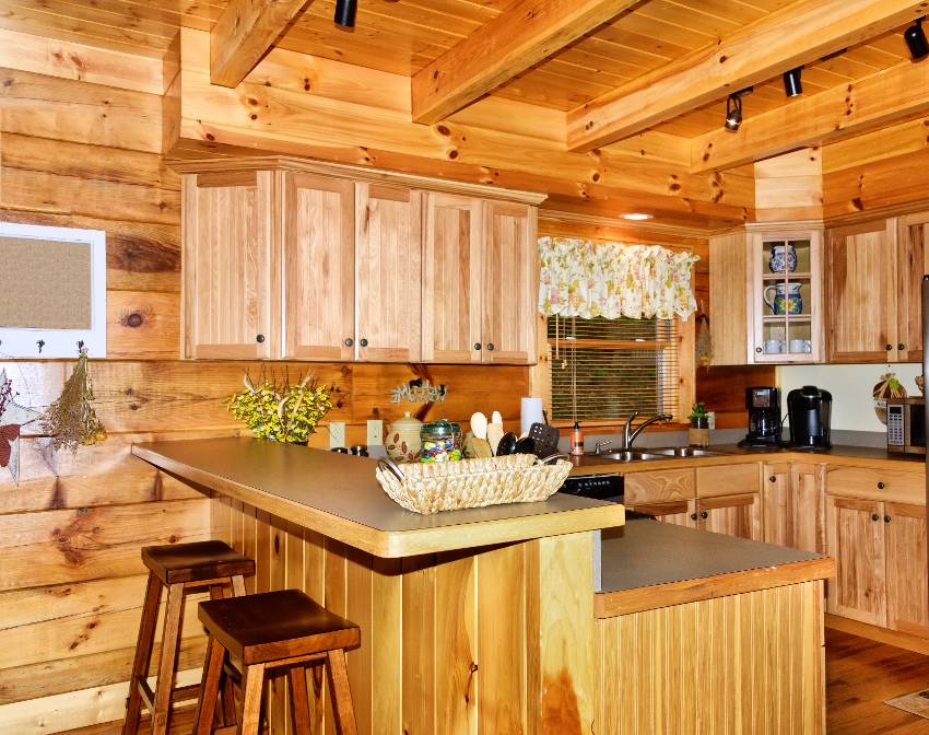 Kitchen with shiplap wall panels and bar area in cozy cabin
